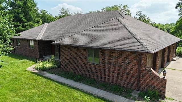 3111 N 35th St, Saint Joseph, MO 64506 - view of side of property featuring a yard, brick siding, and a shingled roof