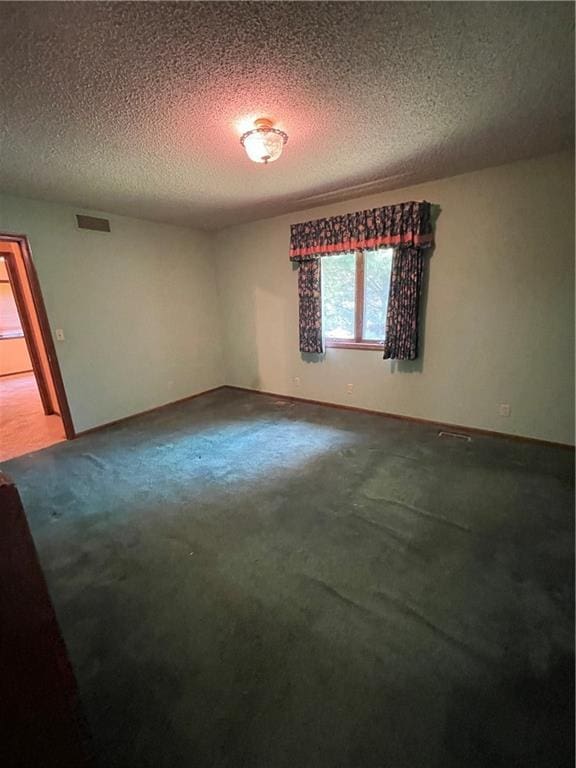 3111 N 35th St, Saint Joseph, MO 64506 - unfurnished room featuring dark carpet and a textured ceiling