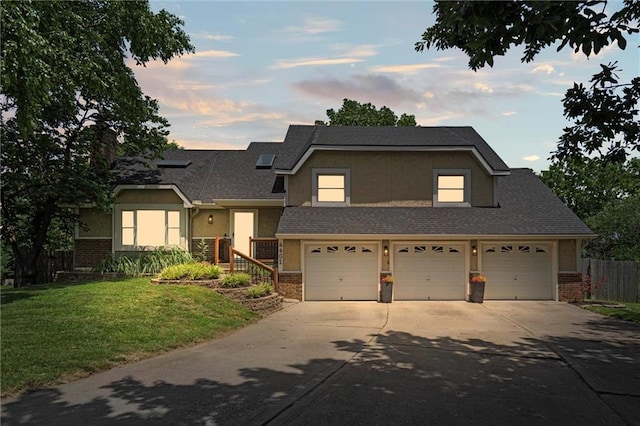 4402 NW 65th Ct, Kansas City, MO 64151 - split level home with brick siding, concrete driveway, an attached garage, and stucco siding