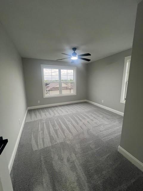 26433 W 144th Ter, Olathe, KS 66061 - spare room featuring carpet and a ceiling fan