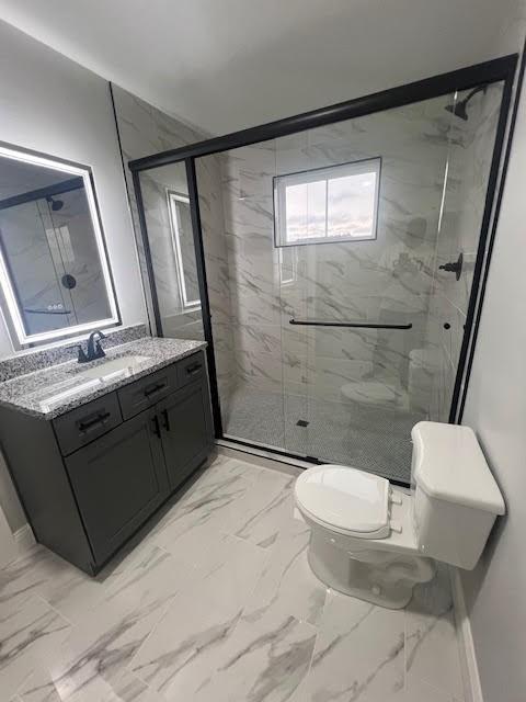 26433 W 144th Ter, Olathe, KS 66061 - bathroom with marble finish floors, vanity, and a marble finish shower