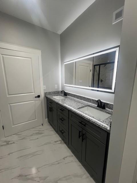 26433 W 144th Ter, Olathe, KS 66061 - bathroom featuring double vanity, marble finish floors, and a shower with shower door