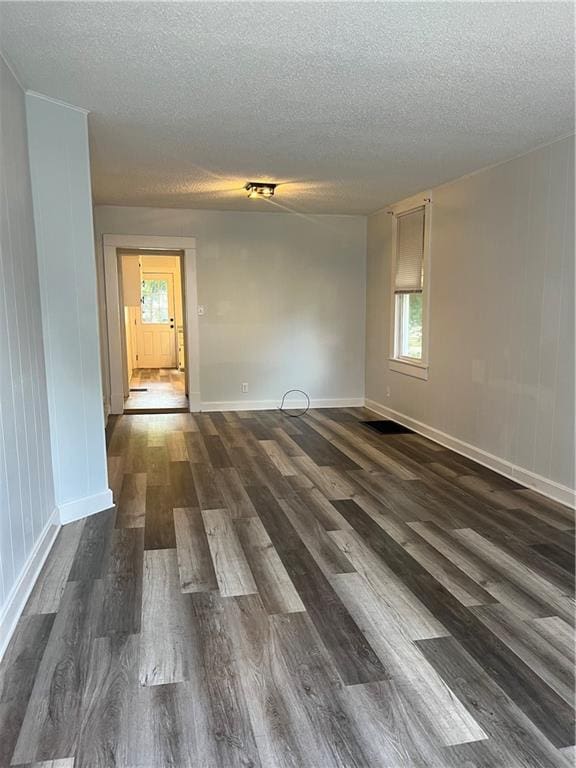 2830 Jules St, Saint Joseph, MO 64501 - unfurnished room featuring a textured ceiling and dark wood finished floors