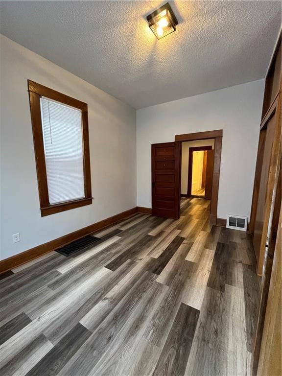 2830 Jules St, Saint Joseph, MO 64501 - empty room featuring dark wood-type flooring and a textured ceiling