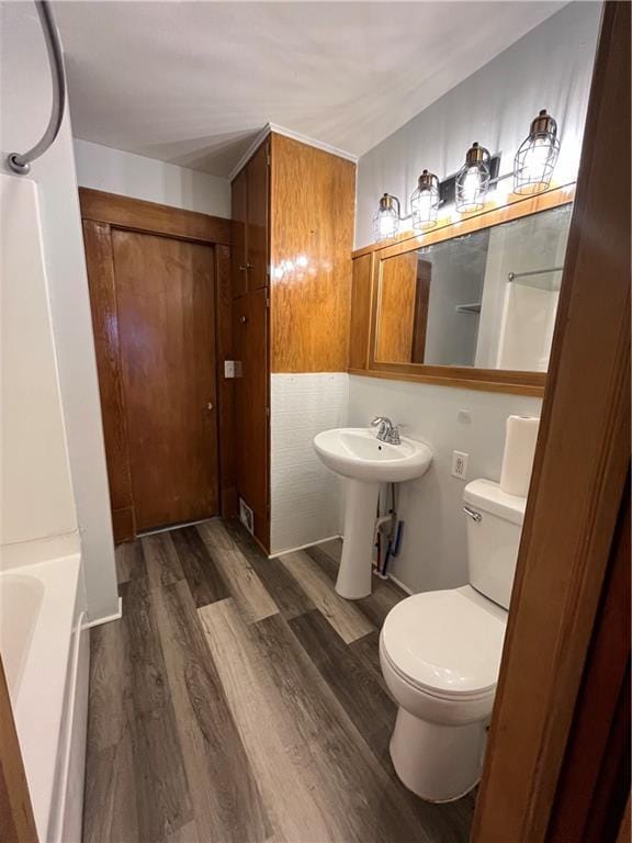 2830 Jules St, Saint Joseph, MO 64501 - bathroom with wood finished floors and a bathtub