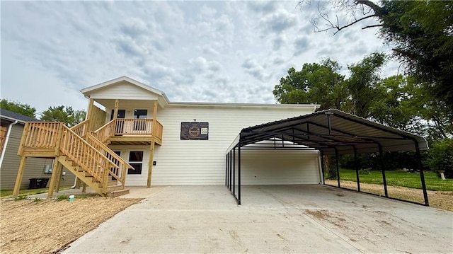 719 E Culton St, Warrensburg, MO 64093 - view of front of property featuring concrete driveway, stairs, and a carport
