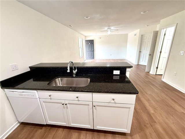 719 E Culton St, Warrensburg, MO 64093 - kitchen featuring dishwasher, wood finished floors, dark stone countertops, and white cabinetry