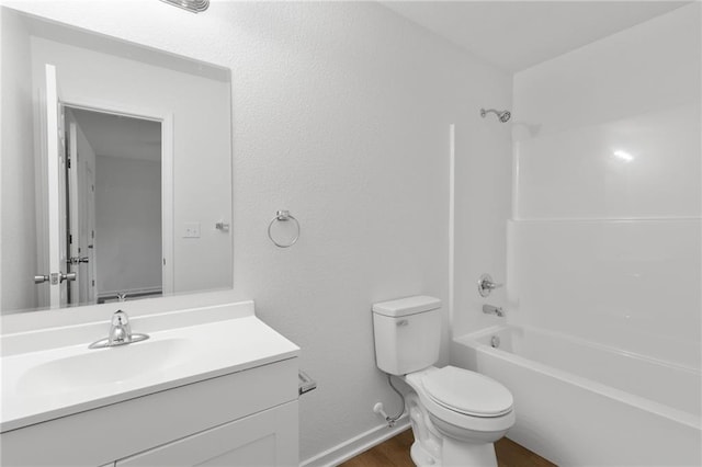719 E Culton St, Warrensburg, MO 64093 - full bathroom with vanity, shower / washtub combination, and wood finished floors