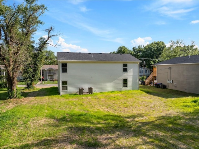719 E Culton St, Warrensburg, MO 64093 - rear view of property with a lawn and stairs