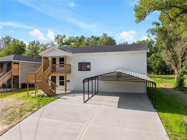 719 E Culton St, Warrensburg, MO 64093 - view of front facade with stairway, a front yard, a carport, and concrete driveway