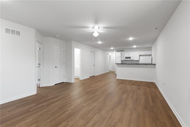 719 E Culton St, Warrensburg, MO 64093 - unfurnished living room with a ceiling fan, dark wood finished floors, and recessed lighting