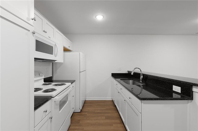719 E Culton St, Warrensburg, MO 64093 - kitchen with white appliances, white cabinetry, a peninsula, dark wood-type flooring, and recessed lighting
