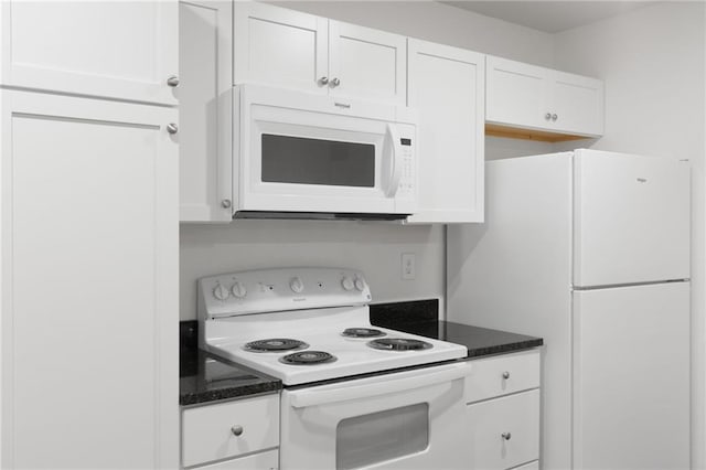 719 E Culton St, Warrensburg, MO 64093 - kitchen featuring white appliances, white cabinets, and dark stone countertops