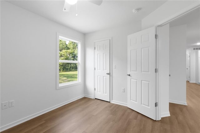 719 E Culton St, Warrensburg, MO 64093 - unfurnished bedroom with wood finished floors, a ceiling fan, and a closet