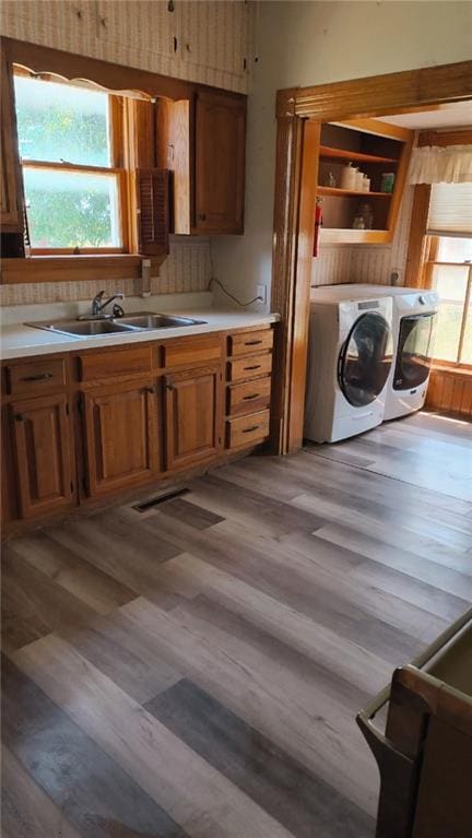 627 50th Rd, Toronto, KS 66777 - kitchen with separate washer and dryer, brown cabinetry, light countertops, and light wood-type flooring