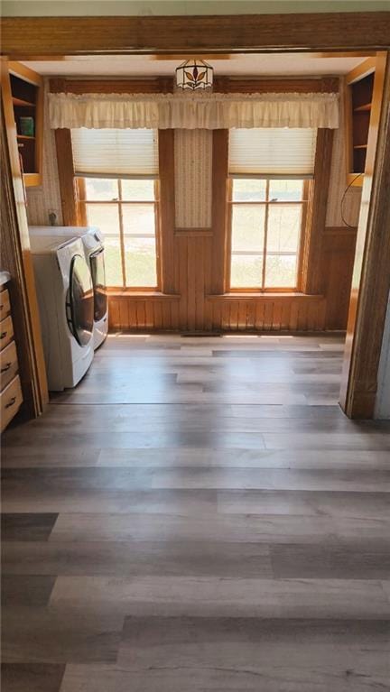 627 50th Rd, Toronto, KS 66777 - laundry area with healthy amount of natural light, wood finished floors, washer and clothes dryer, and wood walls