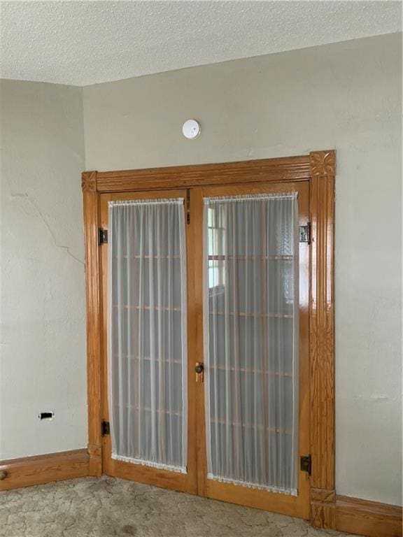 627 50th Rd, Toronto, KS 66777 - doorway to outside with french doors, a textured ceiling, and carpet floors