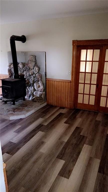627 50th Rd, Toronto, KS 66777 - living area featuring wood finished floors, a wainscoted wall, and a wood stove