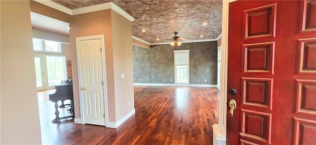 789 Maple Rd, Uniontown, KS 66779 - foyer with dark wood-style flooring, a ceiling fan, and ornamental molding