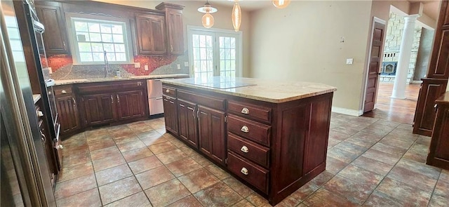 789 Maple Rd, Uniontown, KS 66779 - kitchen with dishwasher, tasteful backsplash, a center island, decorative light fixtures, and dark brown cabinets