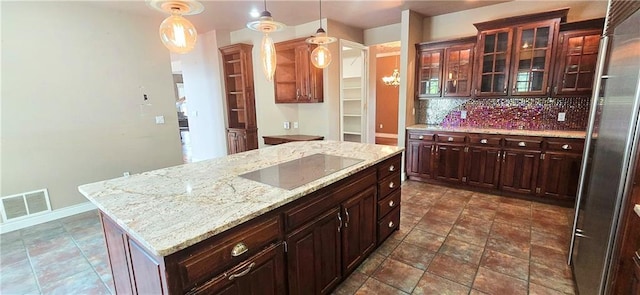 789 Maple Rd, Uniontown, KS 66779 - kitchen featuring black electric cooktop, high end refrigerator, tasteful backsplash, pendant lighting, and glass insert cabinets