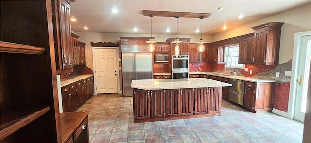 789 Maple Rd, Uniontown, KS 66779 - kitchen with stainless steel appliances, a kitchen island, backsplash, pendant lighting, and dark brown cabinetry