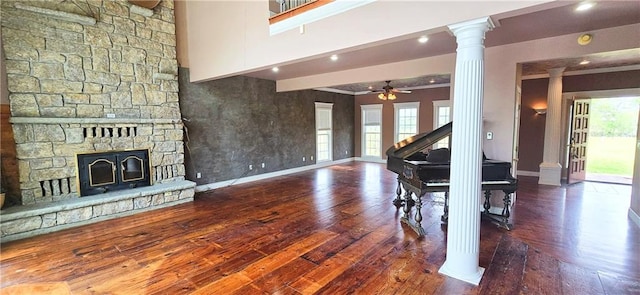 789 Maple Rd, Uniontown, KS 66779 - living area featuring ornate columns, hardwood / wood-style floors, a ceiling fan, a stone fireplace, and recessed lighting