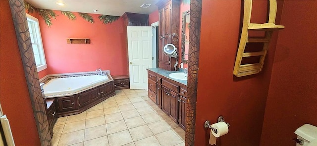 789 Maple Rd, Uniontown, KS 66779 - full bath with vanity, a garden tub, and tile patterned floors