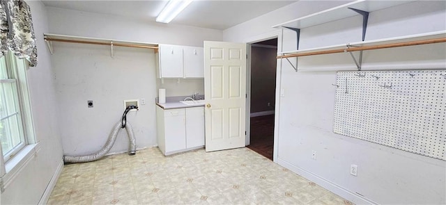 789 Maple Rd, Uniontown, KS 66779 - washroom featuring washer hookup, cabinet space, electric dryer hookup, and light floors