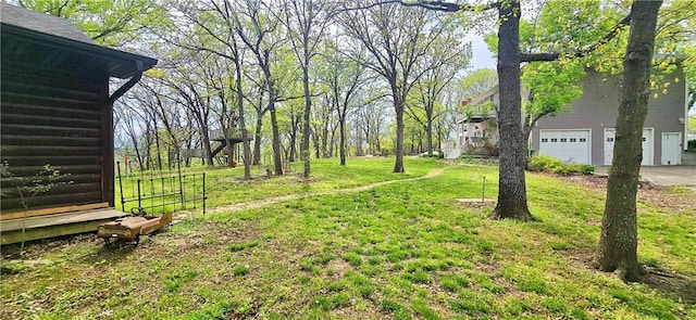 789 Maple Rd, Uniontown, KS 66779 - view of green lawn featuring an attached garage
