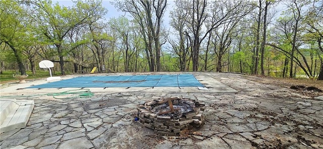789 Maple Rd, Uniontown, KS 66779 - view of pool featuring a patio, an outdoor fire pit, and a covered pool