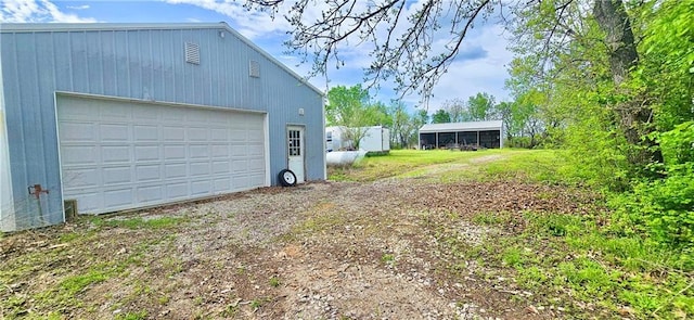 789 Maple Rd, Uniontown, KS 66779 - view of yard with an outbuilding and a garage