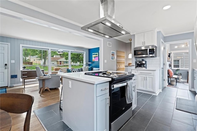 5001 W 70th St, Prairie Village, KS 66208 - kitchen featuring stainless steel appliances, island exhaust hood, white cabinets, healthy amount of natural light, and crown molding