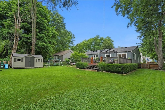 5001 W 70th St, Prairie Village, KS 66208 - view of yard with a shed, a wooden deck, a pergola, and a playground