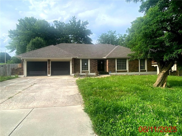9048 E 51st Ter, Kansas City, MO 64133 - ranch-style home featuring an attached garage and concrete driveway