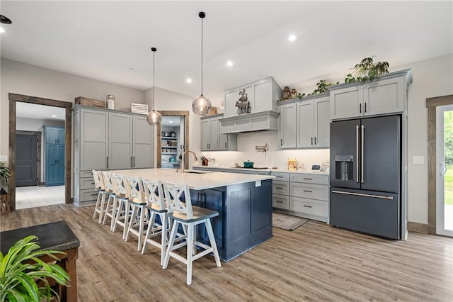 31788 W 223rd St, Spring Hill, KS 66083 - kitchen featuring high end refrigerator, gray cabinets, light wood finished floors, light countertops, and a kitchen island with sink