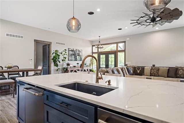 31788 W 223rd St, Spring Hill, KS 66083 - kitchen featuring open floor plan, blue cabinets, pendant lighting, light stone countertops, and recessed lighting
