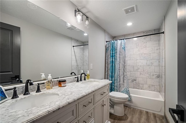 31788 W 223rd St, Spring Hill, KS 66083 - bathroom featuring wood finished floors, double vanity, shower / tub combo with curtain, and a textured ceiling