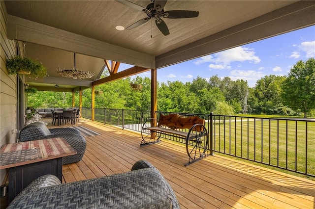 31788 W 223rd St, Spring Hill, KS 66083 - deck with outdoor dining area, a ceiling fan, and view of wooded area