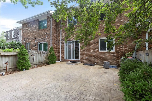 10017 W 95th St, Overland Park, KS 66212 - back of house with a patio area and brick siding
