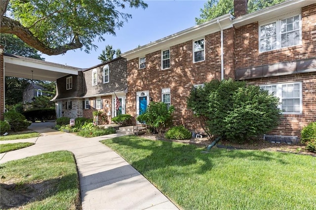 10017 W 95th St, Overland Park, KS 66212 - view of front of home featuring a front lawn, brick siding, and a chimney