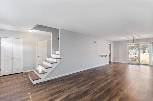 10017 W 95th St, Overland Park, KS 66212 - unfurnished living room with dark wood-style floors and stairs