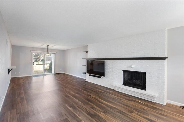 10017 W 95th St, Overland Park, KS 66212 - unfurnished living room featuring a fireplace and wood finished floors