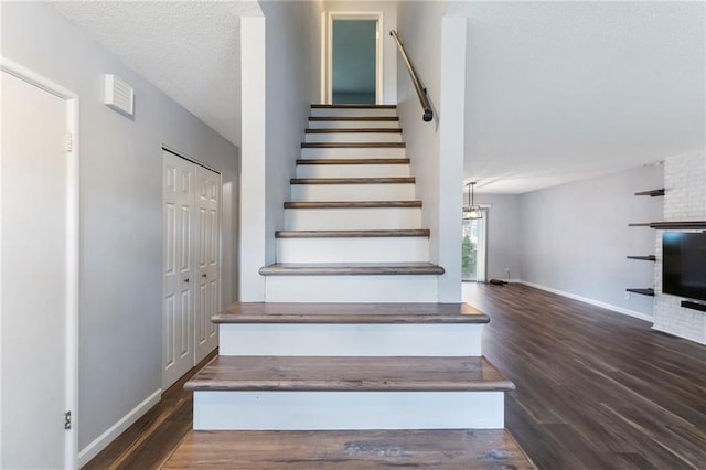 10017 W 95th St, Overland Park, KS 66212 - staircase featuring wood finished floors and a textured ceiling