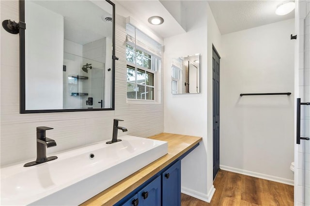 10017 W 95th St, Overland Park, KS 66212 - full bathroom featuring tasteful backsplash, vanity, tiled shower, and wood finished floors