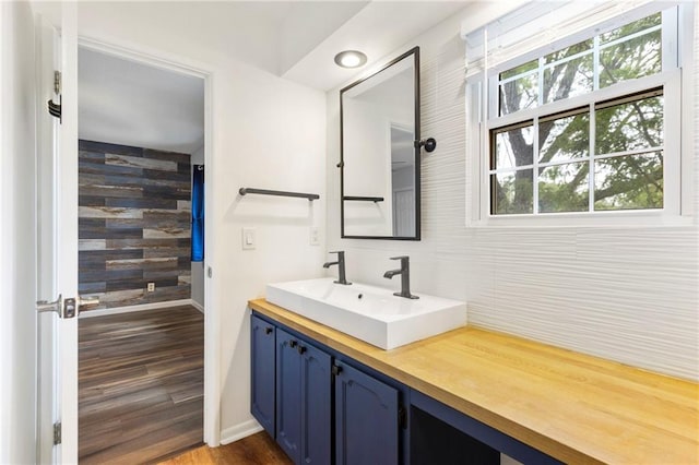10017 W 95th St, Overland Park, KS 66212 - bathroom featuring vanity, wood finished floors, and wooden walls