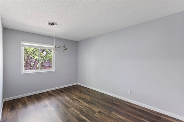 10017 W 95th St, Overland Park, KS 66212 - spare room featuring dark wood-type flooring and a textured ceiling