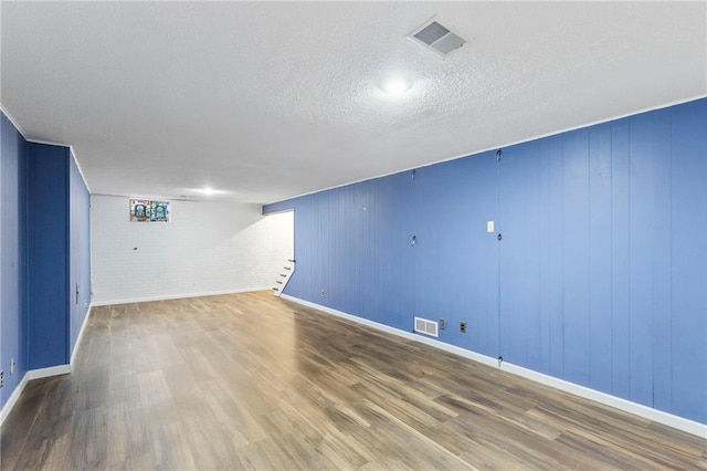 10017 W 95th St, Overland Park, KS 66212 - finished below grade area with wood finished floors, a textured ceiling, and stairs