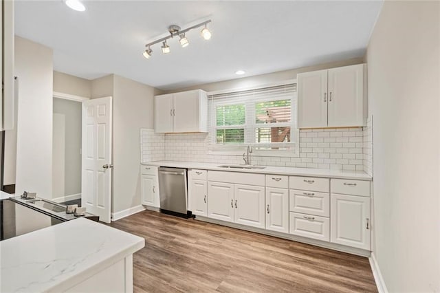 8710 Craig Dr, Overland Park, KS 66212 - kitchen featuring stainless steel dishwasher, white cabinetry, light wood-type flooring, and tasteful backsplash