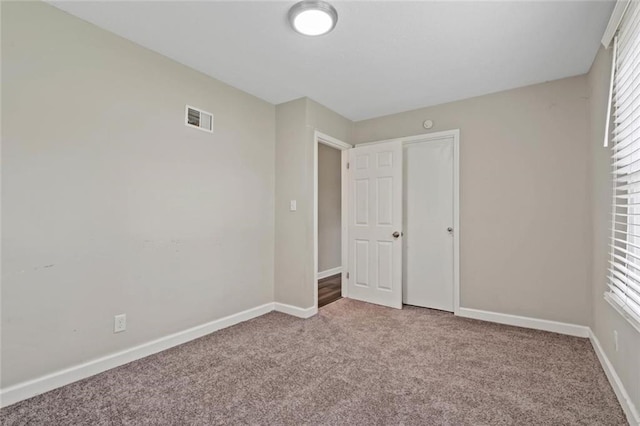 8710 Craig Dr, Overland Park, KS 66212 - unfurnished bedroom with carpet floors and multiple windows